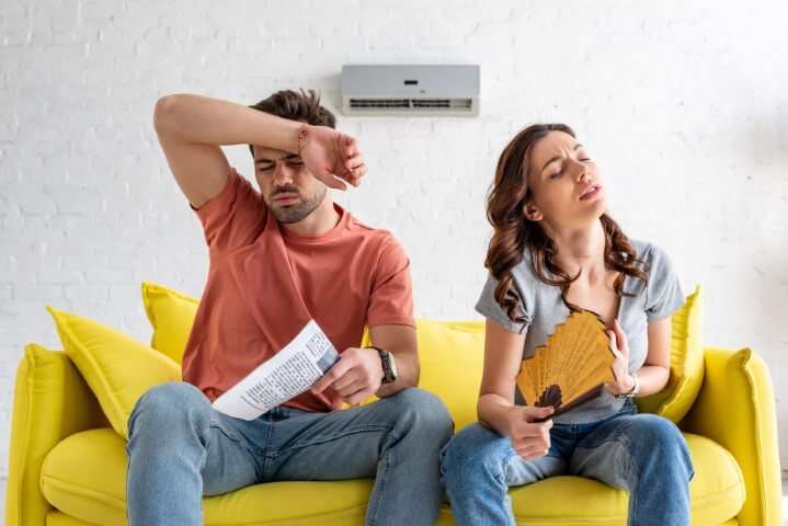 two people overheating because AC is broken